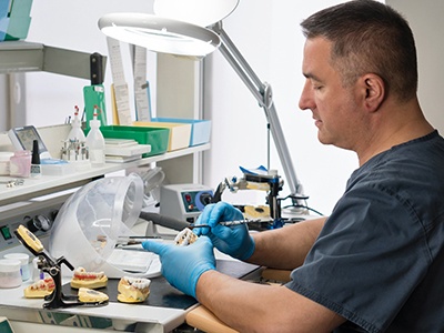 Dentist in Phoenix working on various dentures