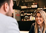 Couple smiling while enjoying coffee together
