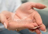 Closeup of patient holding clear aligner
