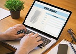 Patient filling out dental insurance form on computer