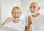 Senior couple brushing their teeth in bathroom