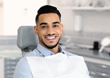 Man smiling while sitting in treatment chair