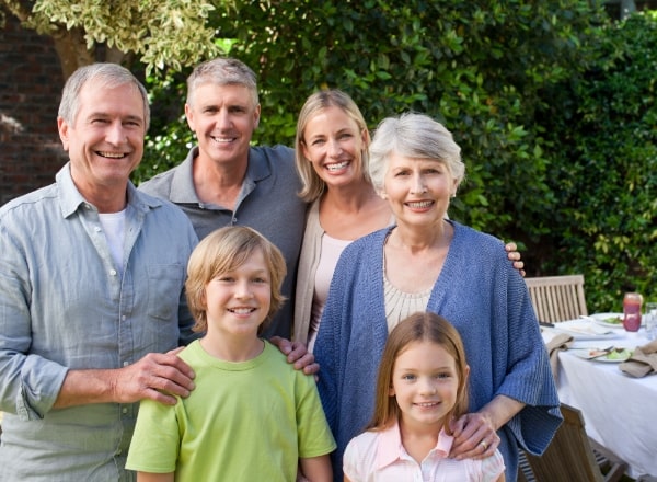 Three generations of family sharing healthy smiles