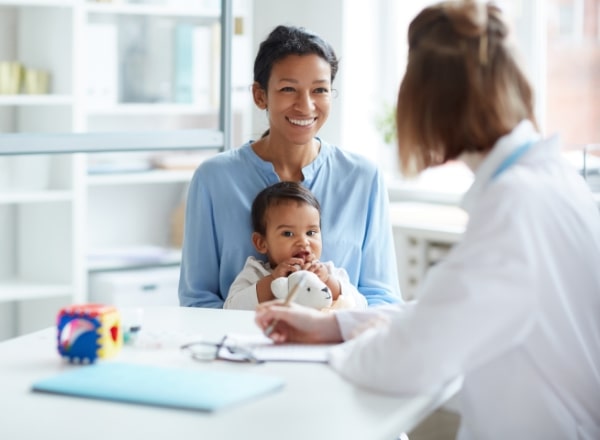 Mother and child smiling at trusted family dentist