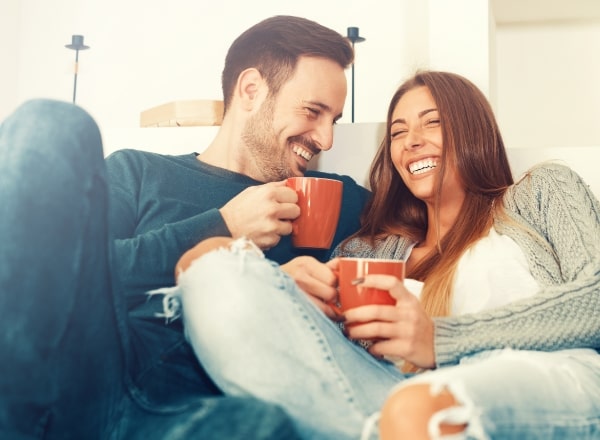 Man and woman enjoying the benefits of all on four dental implants