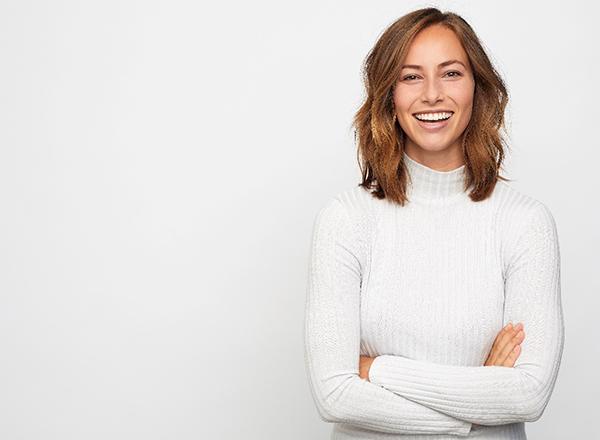 a woman smiling after getting dental bridges in Phoenix 