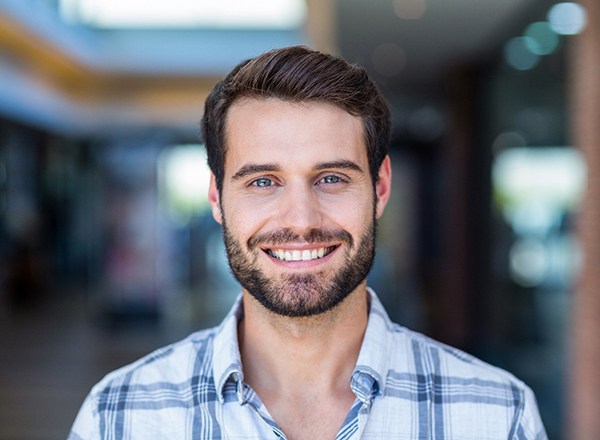 a man smiling with dental bridges in Phoenix