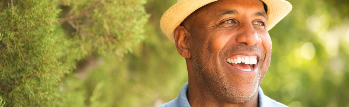 Man with flawless smile after replacing missing teeth