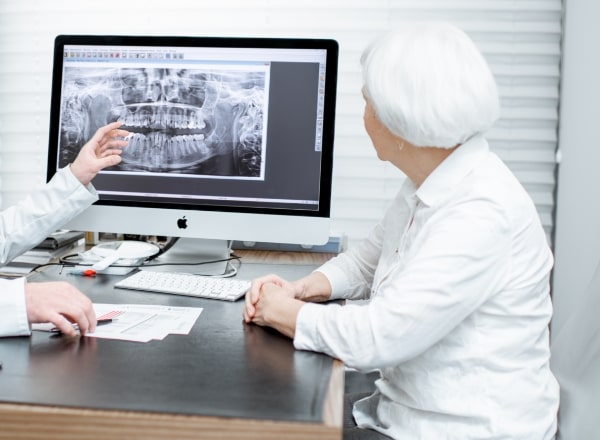 Dentist and patient discussing CEREC one visit dental restorations