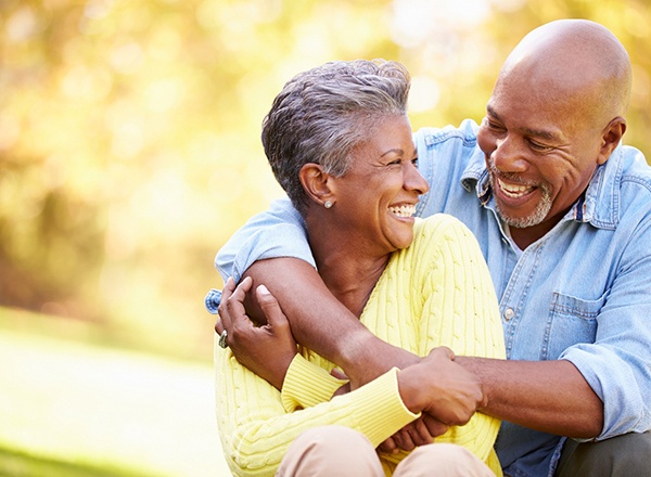 Man and woman spending time outside and smiling