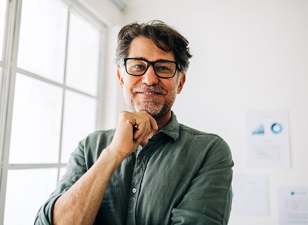 Close-up of senior man with glasses smiling