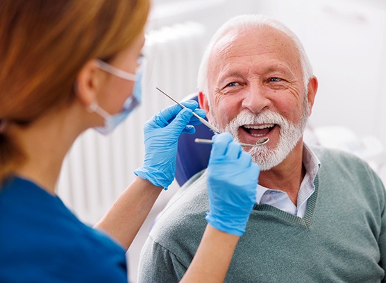 Man smiles at dentist