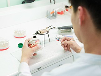 A lab technician creating a set of dentures