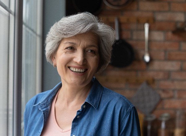 Woman smiling next to window