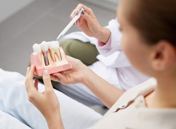 Dentist and patient discussing the cost of dental implants