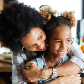 Mother hugging daughter