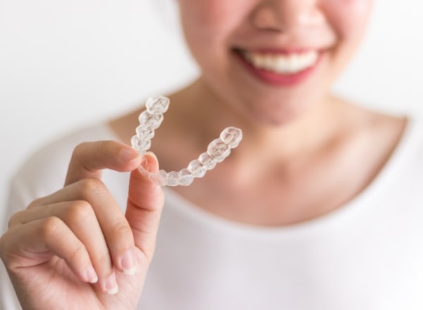 Dental patient holding Invisalign tray