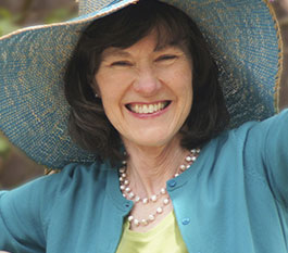 Woman with sunhat smiling and enjoying tooth replacement with dental implants