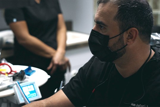 Doctor Jafari talking to dental patient