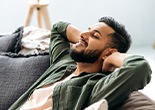 a man resting on his couch