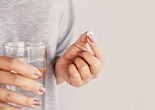 a person preparing to take a pill