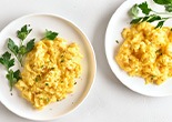 a white plate with scrambled eggs