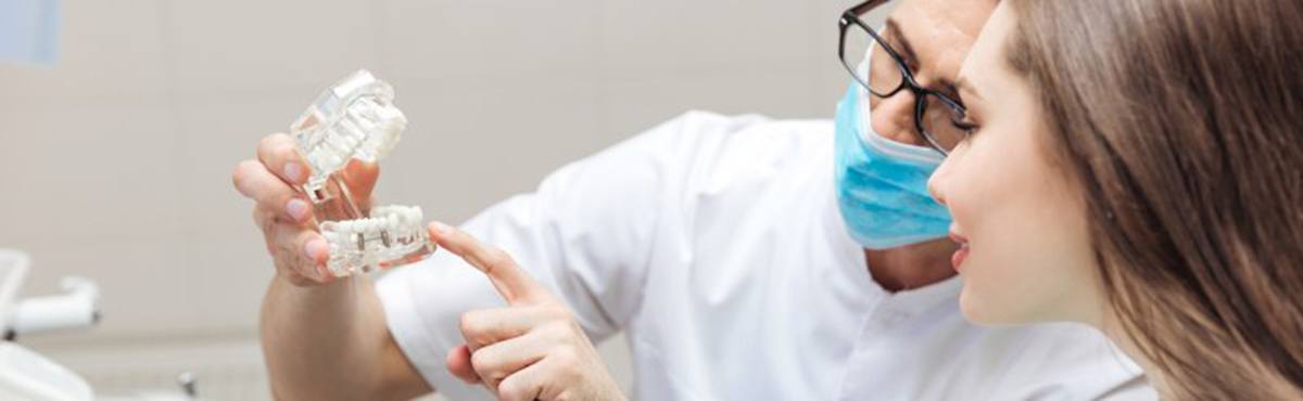 a dentist explaining dental implants to a patient