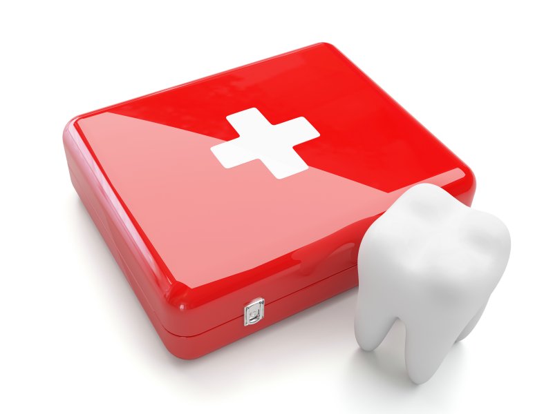 Tooth and medical kit representing an emergency dentist