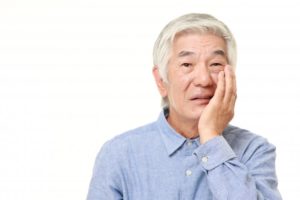 man experiencing sensitivity in a dental implant
