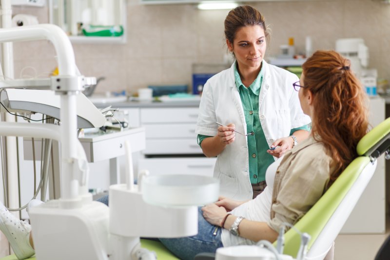 woman learning about early detection of oral health problems in Phoenix