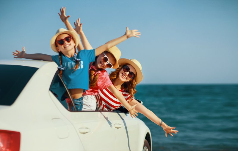 family smiling during summer vacation