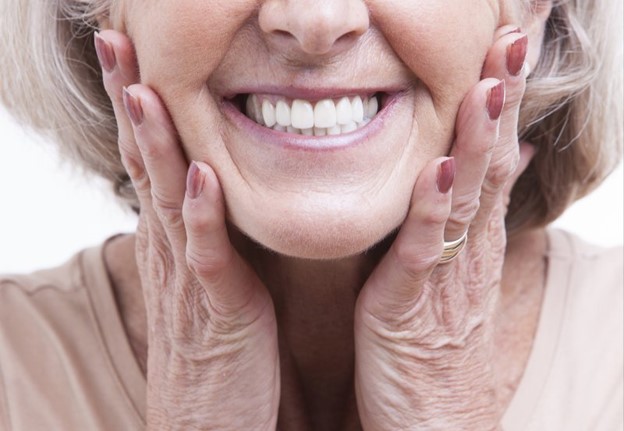 closeup of patient smiling after receiving dental implants 