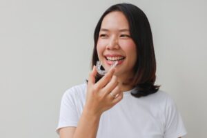 Woman putting on her Invisalign refinement tray